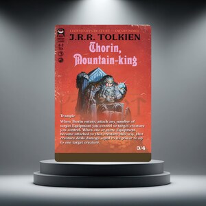 May include: A rectangular trading card with a red background featuring the text J.R.R. Tolkien, Thorin, Mountain-king, and game rules. The central illustration depicts a bearded dwarf sitting on a throne holding a glowing blue orb.