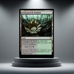 May include: A Magic: The Gathering card named "Undergrowth Stadium" on a plinth. The card shows a forest scene with a circular structure. Text details the card's game mechanics. It is a land card.