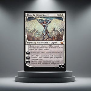 May include: A black Magic: The Gathering card featuring Elspeth, Storm Siever, a Legendary Planeswalker. The card has a white and silver illustration of a winged figure. The card text includes abilities and mana costs.