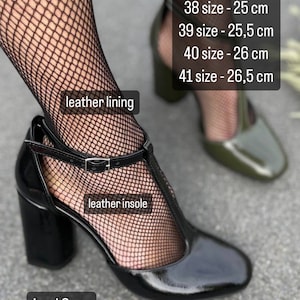 May include: Black patent leather heeled shoes with a t-strap design and an 8 cm heel. The shoes have a leather lining and insole. Size chart included: 35 - 23.5 cm, 36 - 24 cm, 37 - 24.5 cm, 38 - 25 cm, 39 - 25.5 cm, 40 - 26 cm, 41 - 26.5 cm.