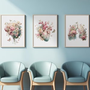 May include: Three framed art prints depicting anatomical illustrations of the brain, heart, and lungs, each adorned with floral arrangements and butterflies. The prints are displayed above three light blue armchairs with wooden legs, against a light blue wall.