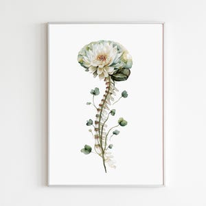 May include: Watercolor art print featuring a spine-like stem topped with a flower resembling a brain. The artwork is in soft, muted tones of white, green, and beige, with delicate leaves and floral details. The print is framed in a silver frame.