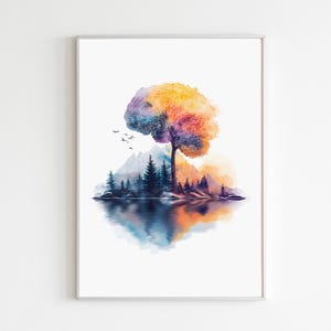 Op de afbeelding: Aquarel kunstafdruk met een levendige boom met een kleurrijk bladerdak van oranje, geel, paars en blauw. De boom staat in de buurt van een meer met bergsilhouetten en groenblijvende bomen. Het kunstwerk heeft een reflecterend watereffect en een witte achtergrond.