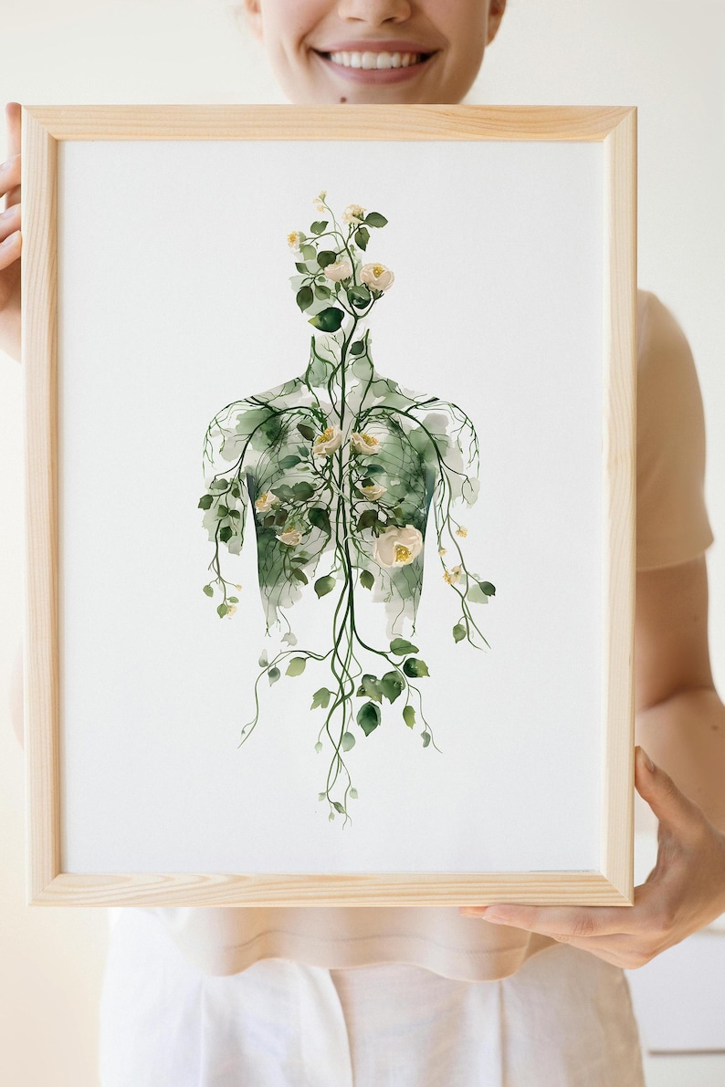 May include: Watercolor print in a light wooden frame. The artwork depicts a human torso silhouette filled with green vines, leaves, and white flowers. The image has a soft, ethereal quality, suitable for home decor.