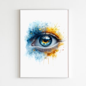 May include: A framed watercolor print of a human eye. The eye features a vibrant blue iris with gold and yellow accents. The artwork is set against a white background, with blue and yellow watercolor splashes surrounding the eye.