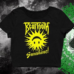 May include: Black crop top with a yellow graphic of a sun with a smiley face and the text "Beartooth Sunshine!"