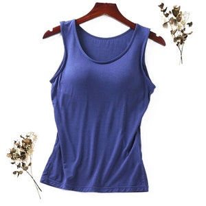 May include: A sleeveless blue tank top with a built-in bra. The tank top is made of a soft, stretchy fabric and has a scoop neck.