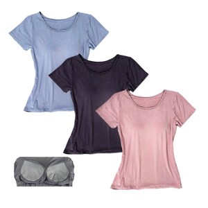 May include: Three short-sleeved shirts in different colours: light blue, dark purple, and light pink. The shirts have a round neckline and a fitted silhouette.