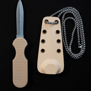 May include: A small, silver knife with a beige handle and a chain attached to a beige leather sheath. The sheath has six brass eyelets.