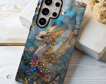 May include: A smartphone case with a stained-glass effect dragon design. The case has a blue background with a dragon in the center, surrounded by colorful flowers. The dragon has gold and silver accents.