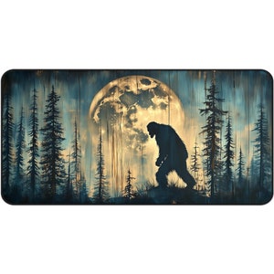 May include: A silhouette of Bigfoot walking through a forest under a large, yellow moon. The moon is surrounded by dark blue trees. The background is a dark blue and brown woodgrain pattern.