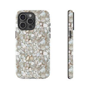 May include: A white and beige iPhone case with a textured pattern of small, irregular shapes. The case has a black camera cutout and a black border.