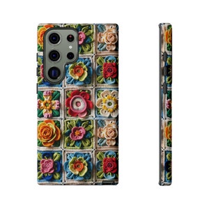 May include: A phone case featuring a colourful crocheted floral pattern. The case is made from a durable material and has a cut-out for the camera lens.