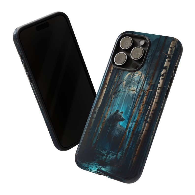 May include: A black phone case with a blue and white forest scene and a black bear silhouette. The case has a moon and trees in the background.
