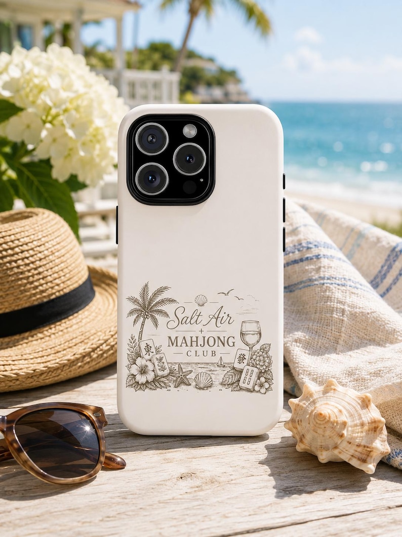 May include: A matte off-white smartphone case featuring a detailed dark brown line art illustration. The design includes a palm tree, hibiscus flowers, seashells, a wine glass, and mahjong tiles with the text Salt Air Mahjong Club.