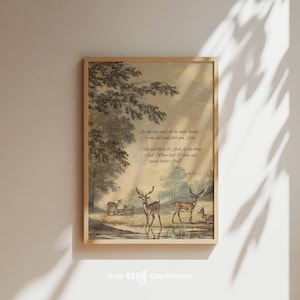 May include: A framed art print with a vintage illustration of deer by water, with a quote from Psalm 42:1-2. The print is in a wooden frame. Ideal for home decor, the artwork has a classic, timeless feel.