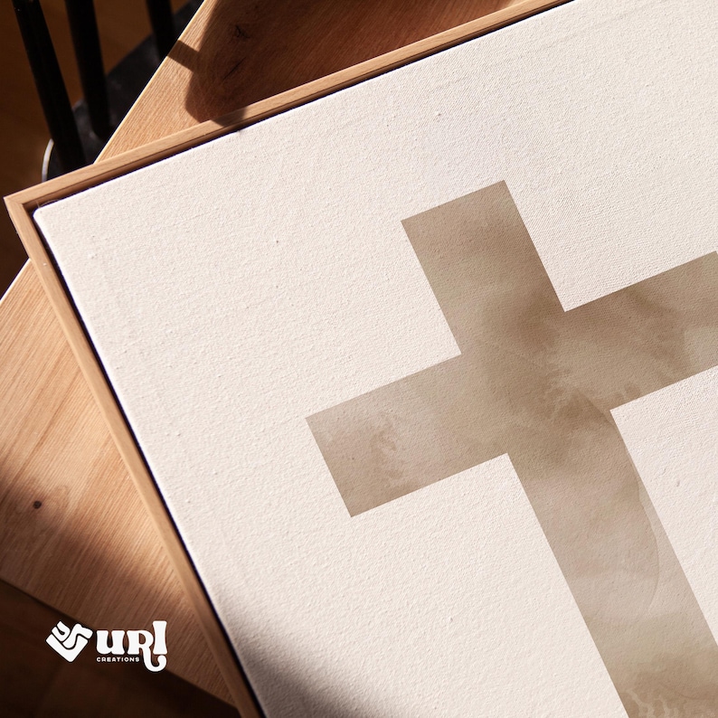 A minimalist watercolor cross printable wall art in soft, neutral earthy tones. The design features a subtle, abstract texture, creating a peaceful and elegant Christian decor piece. Perfect for Easter celebrations, religious home decor, or faith-inspired artwork.