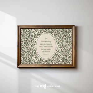 May include: A framed print with a brown wooden frame. The print features a beige background with a green leaf pattern. An oval in the centre contains the text "To every thing there is a season, and a time to every purpose under the heaven."