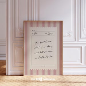 May include: A framed print featuring a note-style design with the text "You don't know what I am doing now, but you will understand later." The print has a pink and white striped border and the text "John 13:7."