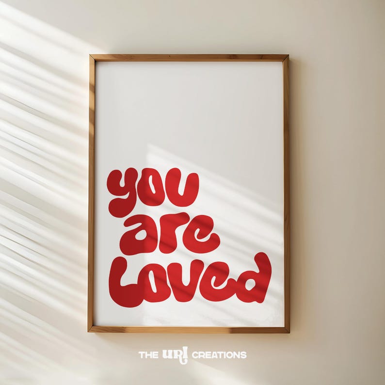 This You Are Loved Wall Art is a Christian inspired wall art. It has a funky playful font text in color Red on white background. Perfect for Valentines Day decor, Girls Bedroom Decor, and a gift for daughter