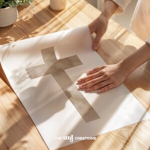 A minimalist watercolor cross printable wall art in soft, neutral earthy tones. The design features a subtle, abstract texture, creating a peaceful and elegant Christian decor piece. Perfect for Easter celebrations, religious home decor, or faith-inspired artwork.