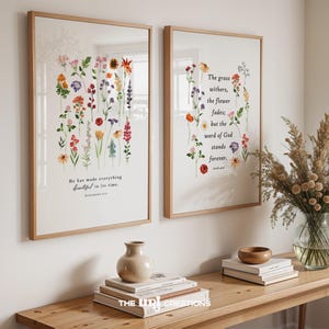 May include: Two framed art prints with botanical illustrations and inspirational quotes. One print features a variety of colorful flowers with the text "He has made everything beautiful in its time." The other print displays a floral arrangement with the quote "The grass withers, the flower fades; but the word of God stands forever."
