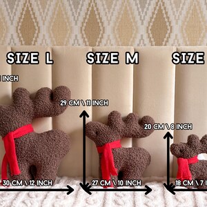 May include: Three brown textured plush reindeer toys with red scarves, labeled Size L, Size M, and Size S. Dimensions are indicated with arrows: Size L is 14 inches high and 12 inches wide, Size M is 11 inches high and 10 inches wide, and Size S is 8 inches high and 7 inches wide.
