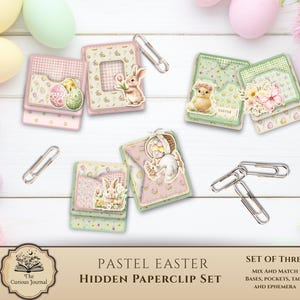 Puede incluir: Juego de clips de papel ocultos Pastel Easter con clips decorativos y bases, bolsillos, etiquetas y efímeras combinables. El juego incluye tarjetas con ilustraciones de huevos y conejos de Pascua en rosa, verde y amarillo.