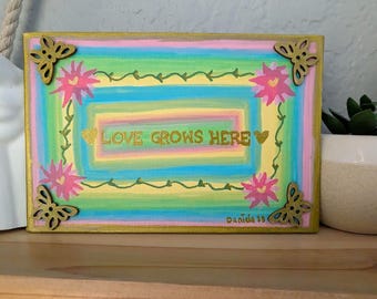 Hand-Painted Love Grows Here Affirmation Canvas Art: Gold Accents, Empowering Words, Butterfly, flower.