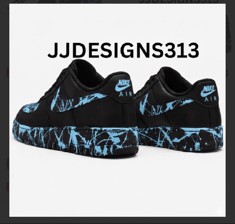 May include: Pair of black Nike Air Force 1 sneakers with light blue splatter paint design on the soles and swoosh logos. The text "JJDESIGNS313" is printed above the shoes.