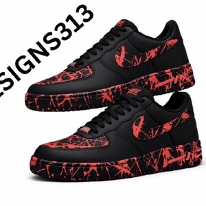 May include: Pair of black sneakers with red splatter design on the soles, toe box, and Nike swoosh. The shoes have black laces and a black tongue. The text "JJDESIGNS313" is in the upper left corner.