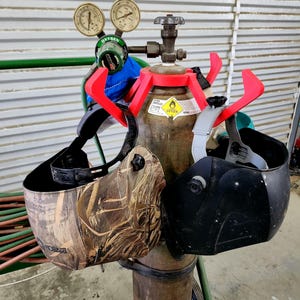 Welding/Shield Holder fits over standard sized oxygen bottle and keeps your safety gear close at hand so you know where it is when it's time to get to work. Design is 3D printed using PLA Filament and can be installed without removing regulator.