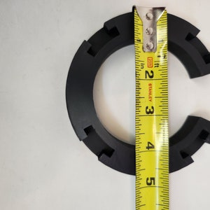 May include: A black plastic ring with a measurement tape showing it is 3 inches in diameter.