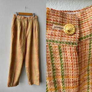 May include: A white ceramic mug with a black handle and the text "But First, Coffee" in a black, handwritten-style font. The mug is on a white surface.