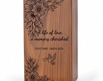 May include: A wooden urn with floral engravings and the text "A life of love, a memory cherished." The dates 15/07/1960 - 08/03/2024 are also displayed. A dove carrying a heart is engraved on the front.