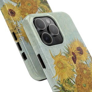 May include: A phone case with a design of sunflowers in a light blue background. The case has a camera lens cutout with a black border.