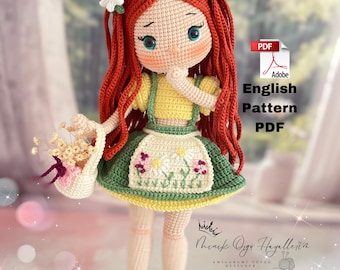 May include: Crochet doll with red hair, a yellow shirt, a green skirt with white flowers, and a basket of flowers. The doll is holding a basket of flowers and has a sweet expression on her face. The doll is wearing green shoes. The image includes the text "English Pattern PDF".
