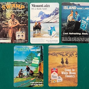 May include: A collection of vintage cigarette advertisements. Each card features a different landscape: a swamp, a mountain scene, an island, a forest, and a plains setting. The ads include text and imagery promoting the product.