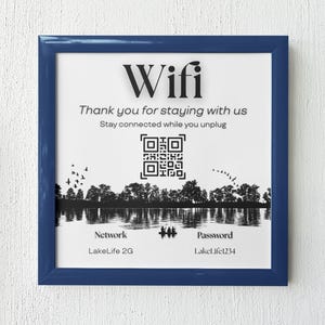 May include: A blue framed sign with the word "Wifi" in large white letters. The sign also includes the text "Thank you for staying with us. Stay connected while you unplug."  A black and white QR code is displayed below the text. The sign also includes the network name "LakeLife 2G" and the password "LakeLife1234".