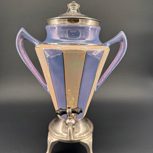 May include: A trio of ceramic mugs with a speckled, matte finish in cream, light grey, and dark grey. Each mug features a simple, minimalist design and a rounded handle.