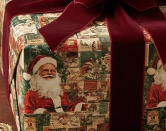 May include: A wrapped gift box with a festive Christmas theme. The wrapping paper features a collage of Santa Claus images and vintage designs. A large, burgundy velvet bow and ribbon adorn the package, creating a luxurious holiday presentation.