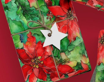May include: Three gift boxes wrapped in red and green watercolor paper with a poinsettia floral design. The boxes are tied with twine and decorated with white paper stars and hearts.