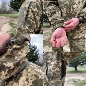 May include: Camouflage jacket with a hood and multiple pockets. The jacket features a zipper closure and a green and brown digital camouflage pattern. Details include a zippered sleeve pocket and adjustable hood drawstrings.