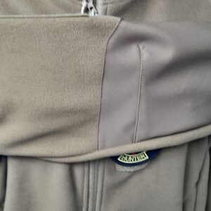 May include: A brown fleece jacket with a zip fastening and a black and gold "Hunter" logo patch on the chest.