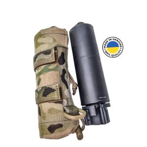 May include: A black suppressor with a push button and a camo pouch. The suppressor has a label that says "Push". The pouch has a tan drawstring. The suppressor is made in Ukraine and has a 100% quality guarantee.
