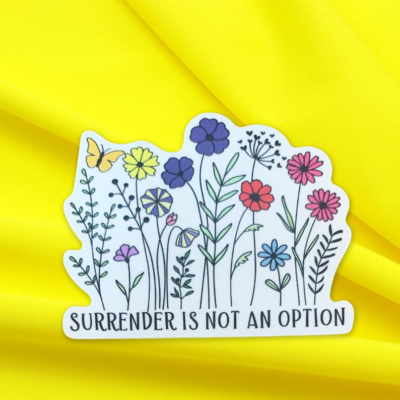 May include: White sticker featuring a colourful floral design and a butterfly. The text "SURRENDER IS NOT AN OPTION" is printed at the bottom of the sticker.
