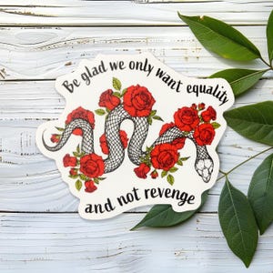 May include: A white sticker with a black snake wrapped in red roses. The text reads "Be glad we only want equality and not revenge."