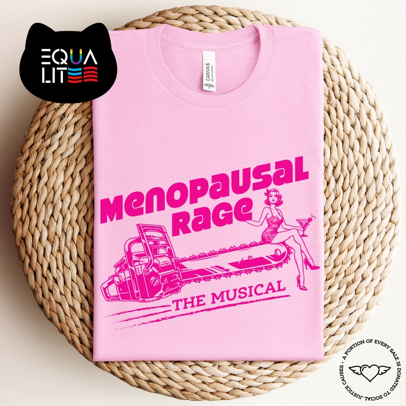 May include: Pink t-shirt with a pink graphic of a woman riding a chainsaw with the text "Menopausal Rage The Musical".