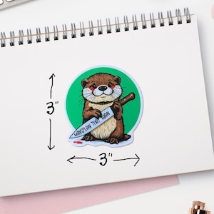 May include: A 3-inch round sticker featuring a cartoon otter holding a knife with the text "Mansplain That Again" on the blade. The otter is brown with a green background.