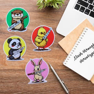 May include: Four colorful stickers featuring cartoon animals holding knives with humorous text. The stickers are on a wooden surface. The text on the stickers reads: "Monosplan that soon", "Let's discuss strategy", "What do you tell me?", and "Don't tell me to smile".